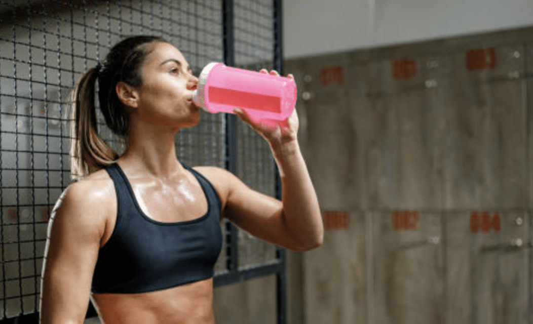 woman enjoying drinking pre-workout